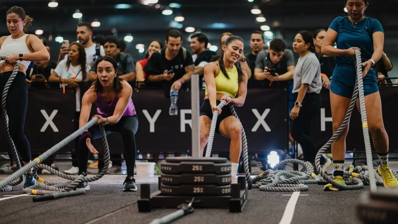 Women pull weighted sledges at a Hyrox competition in Stockholm