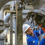 A female oil worker doing maintenance at a liquefied natural gas plant in Nigeria