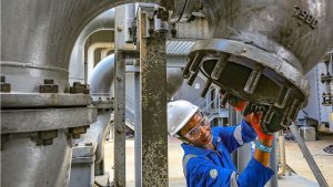 A female oil worker doing maintenance at a liquefied natural gas plant in Nigeria