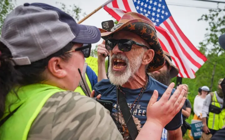 Counter-demonstrator shouting during street protest over immigration enforcement