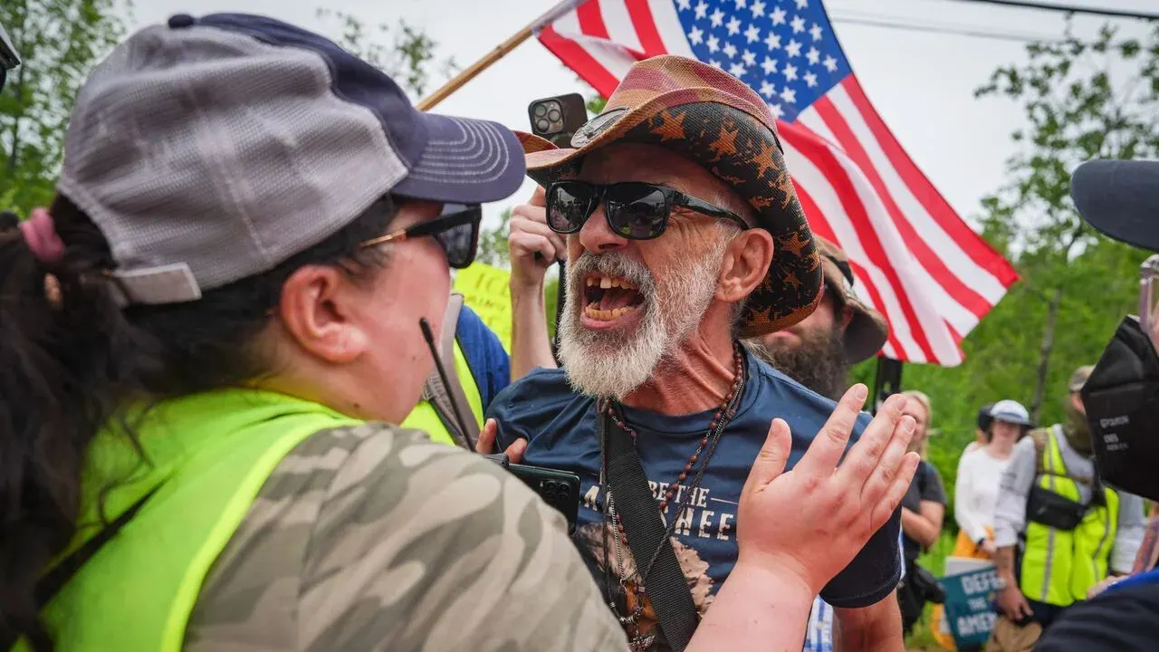 Counter-demonstrator shouting during street protest over immigration enforcement
