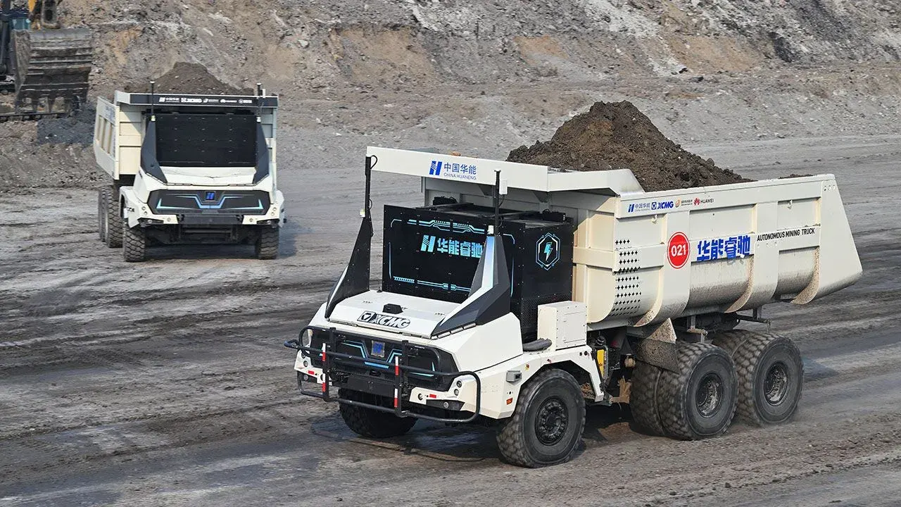 Autonomous haul trucks carrying overburden at China's Yimin coal mine
