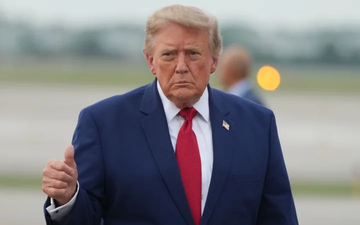 President Donald Trump gives a thumbs-up sign