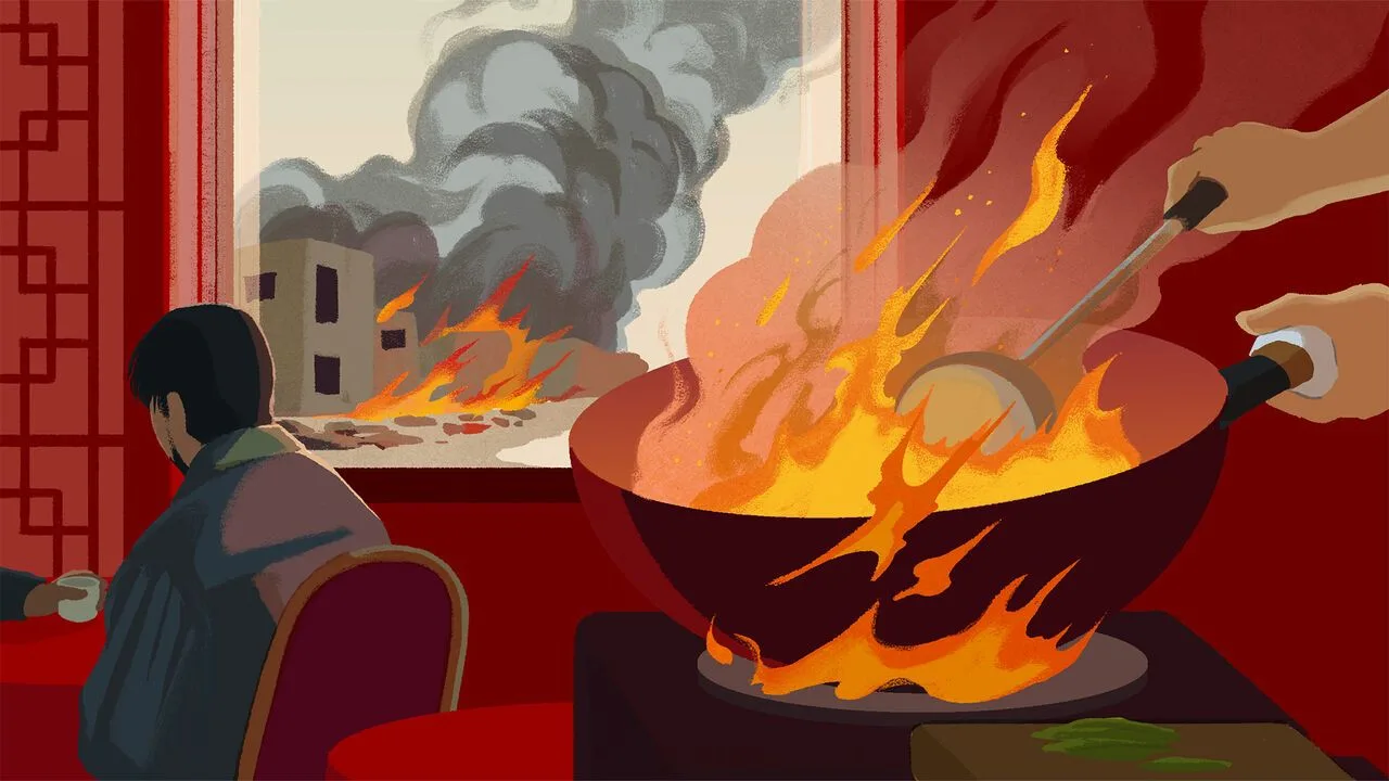 someone cooking with a flaming wok while a building is on fire outside the window
