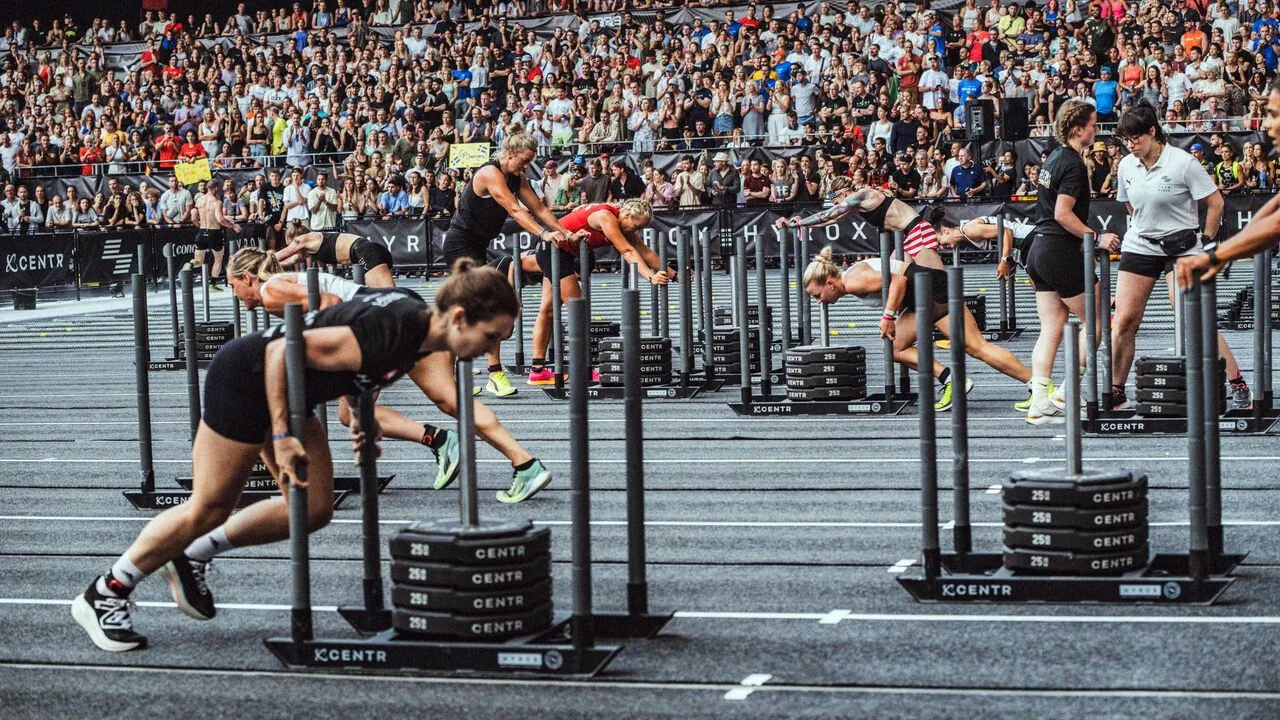 Competitors at a Hyrox event inside an arena