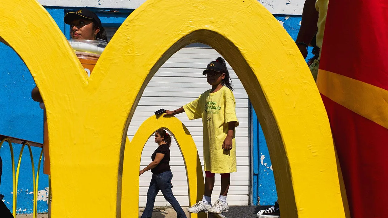 People walk past the McDonald's arches