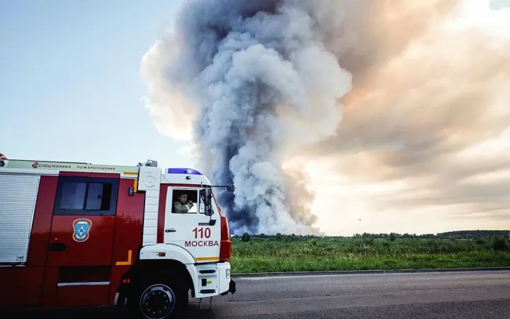 Firefighters pass thick smoke from burning Russian e-commerce warehouse near Moscow