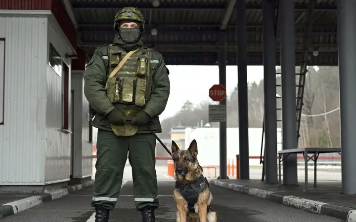 Snow-covered Belarus Ukraine border checkpoint with guards on patrol