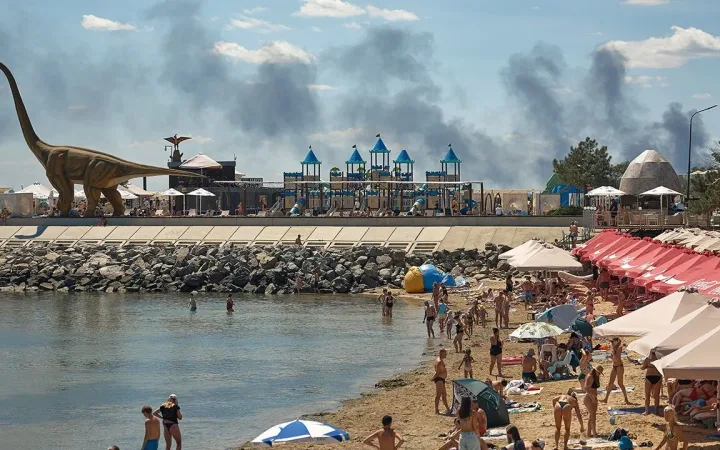 Beachgoers near Odesa as smoke billows after Russian strike on July 29th