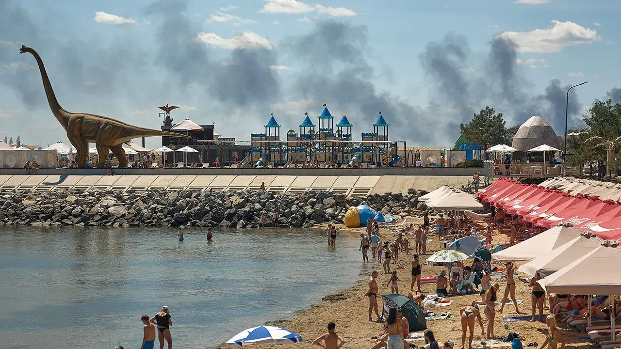 Beachgoers near Odesa as smoke billows after Russian strike on July 29th
