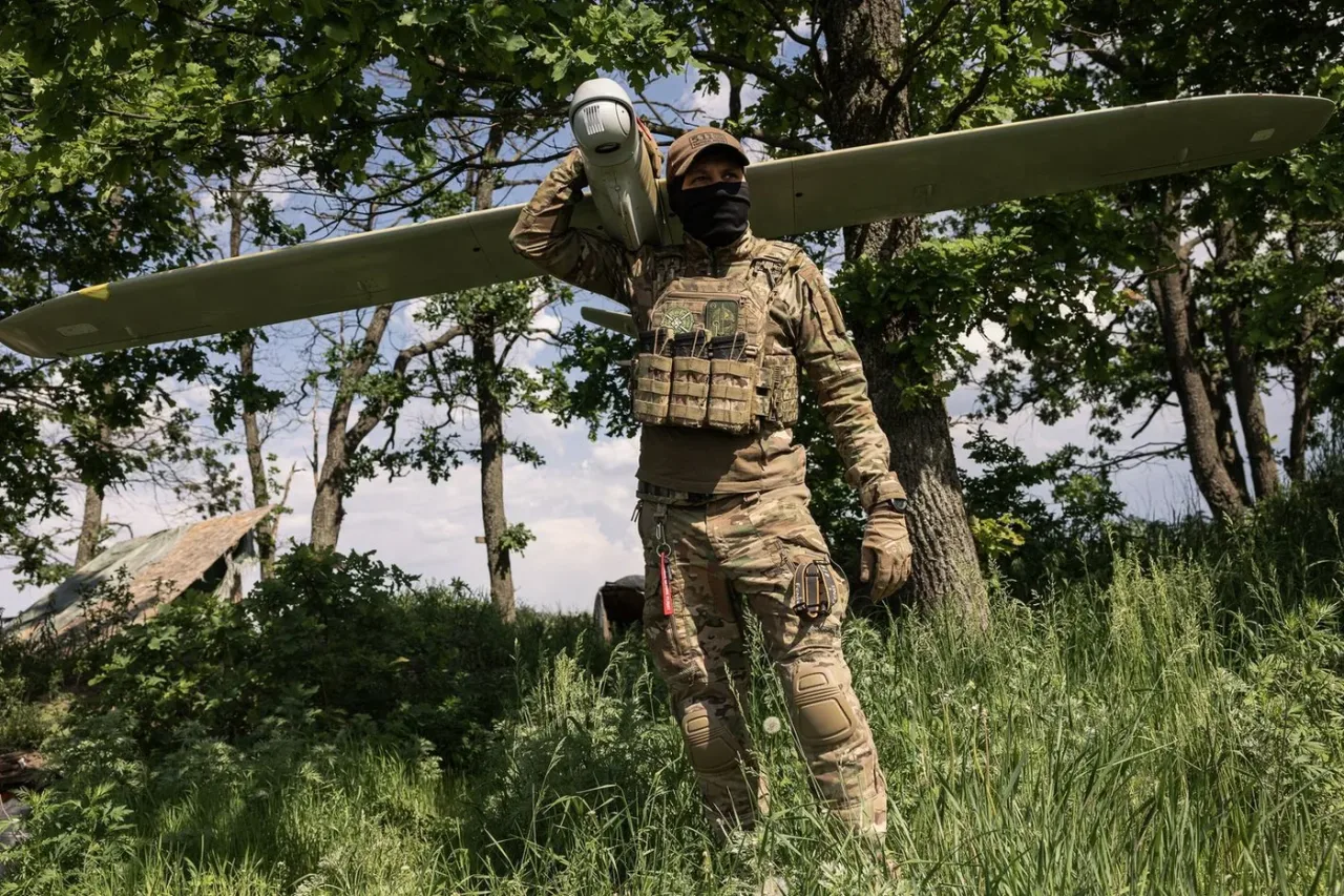 Member of the Lava Unmanned Systems Regiment poses for a photograph with a Leleka reconnaissance UAV in Ukraine.