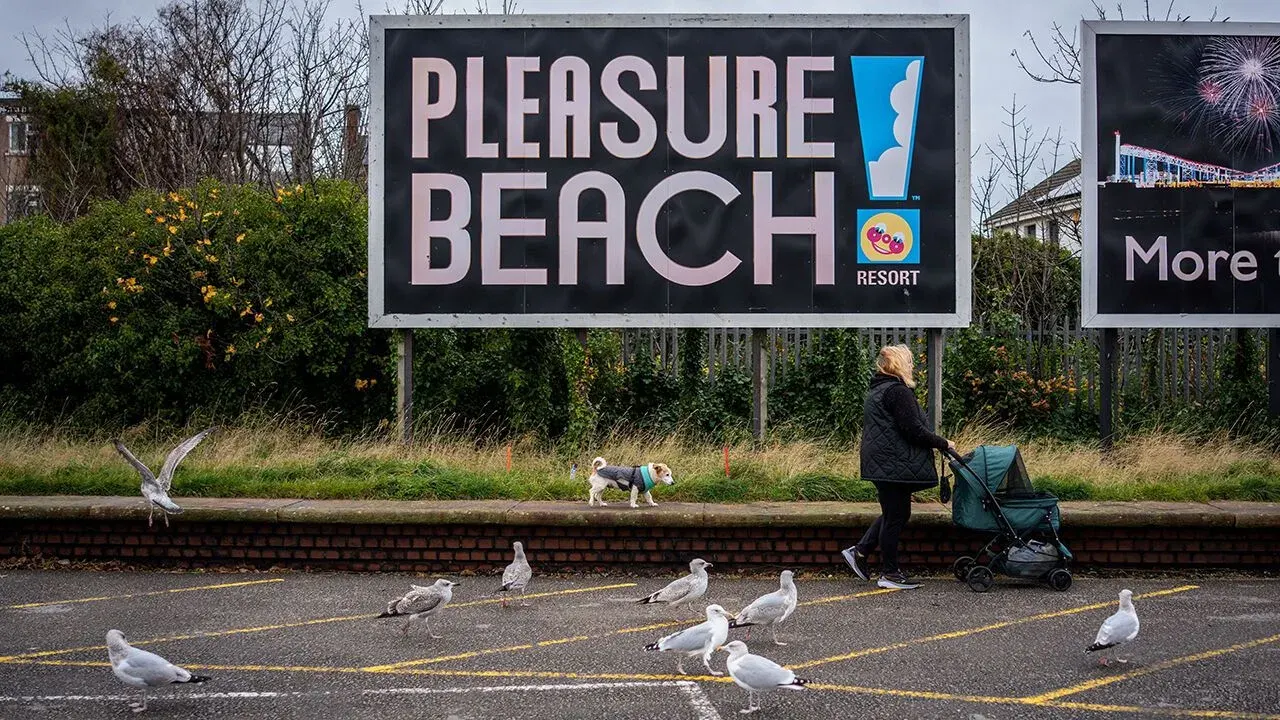 Seagulls follow a woman walking her dog on November 04, 2025 in Blackpool, England.