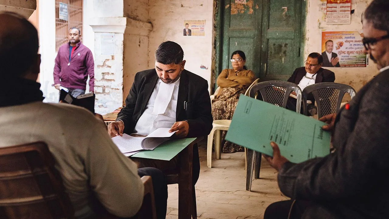 Lawyers prepare paperwork near a court in Mathura, India