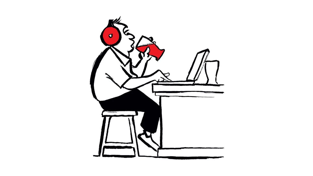 Person wearing red headphones, drinking and working at a laptop computer.