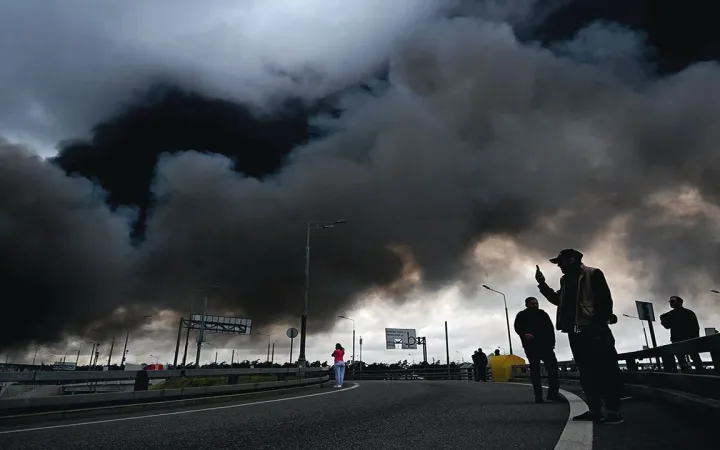 Dark smoke billowing from a Russian refinery fire after a reported strike as crews battle the blaze
