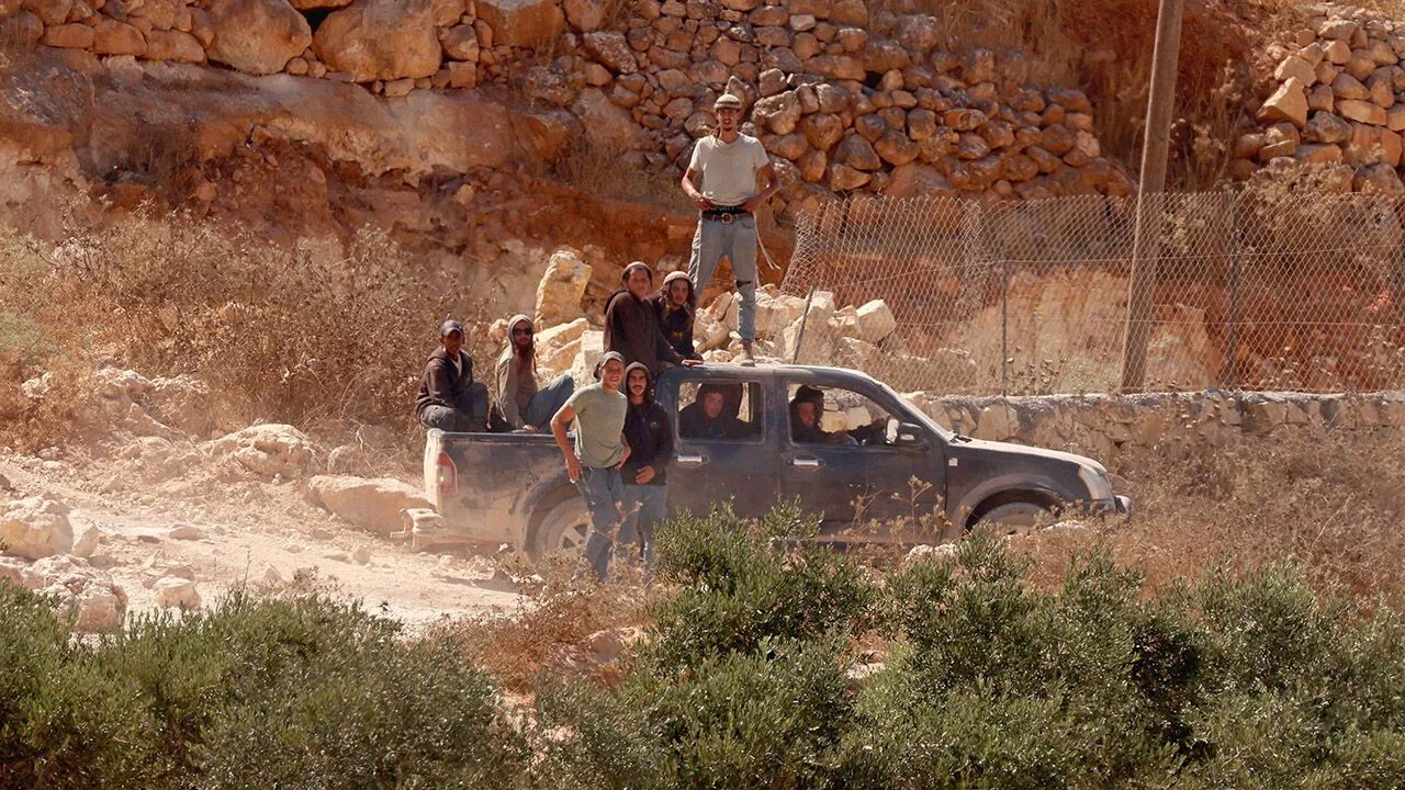 Israeli settlers besiege a Palestinian home in Qusra, Nablus