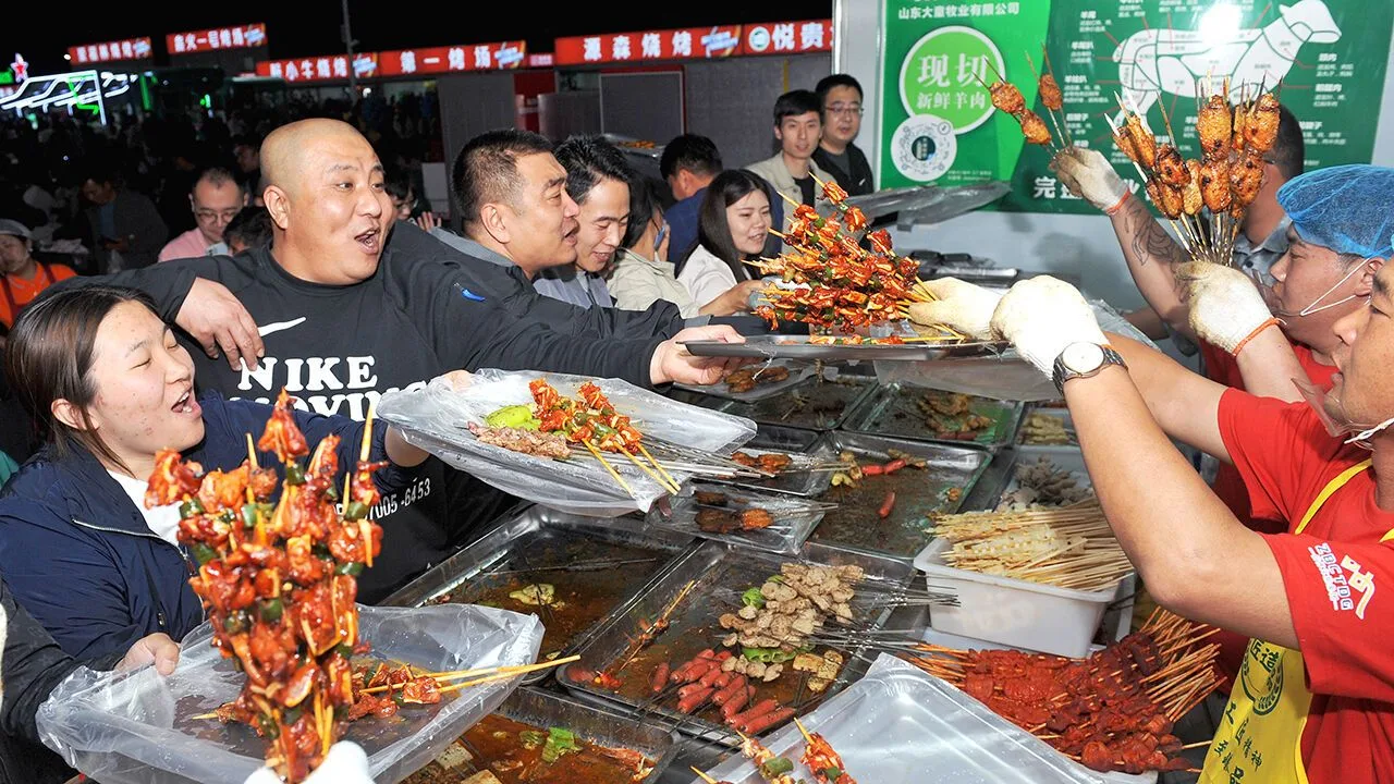 People queueing for skewers at a Chinese barbecue stall