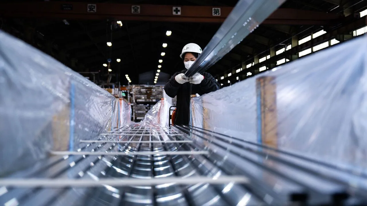 A worker packs aluminum extrusions for shipment at the Kato Light Metal Industry Co. factory in Kanie, Aichi prefecture, Japan.
