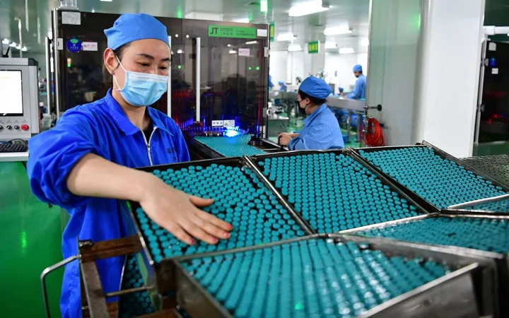 Employees work in a factory of Fusen Pharmaceutical Company in Nanyang, Henan Province, China